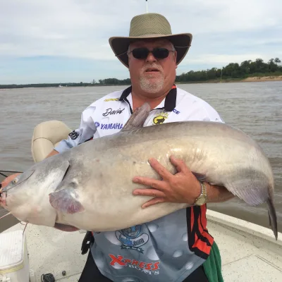 Captain Dave in his fishing hat with a catfish