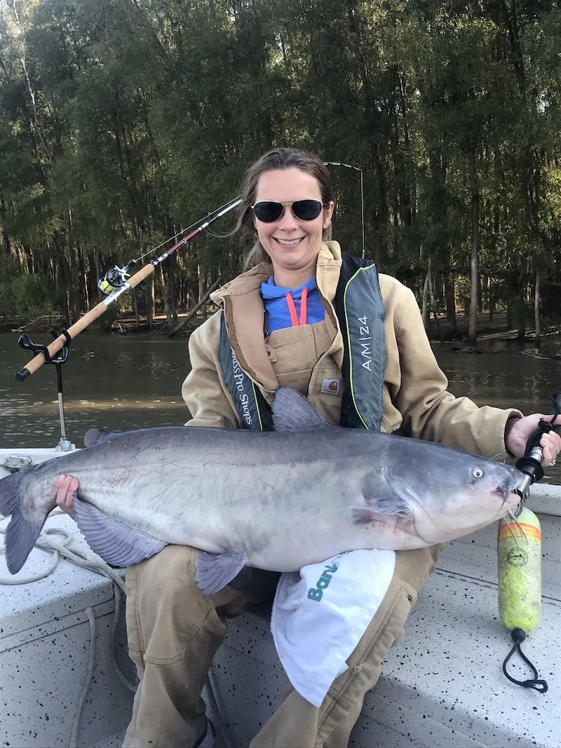 A smiling angler with a large catfish