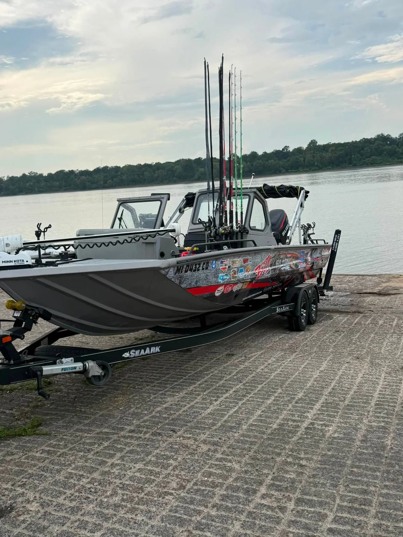 The SeaArk bow, trolling motor, windshield, and rod storage at the launch