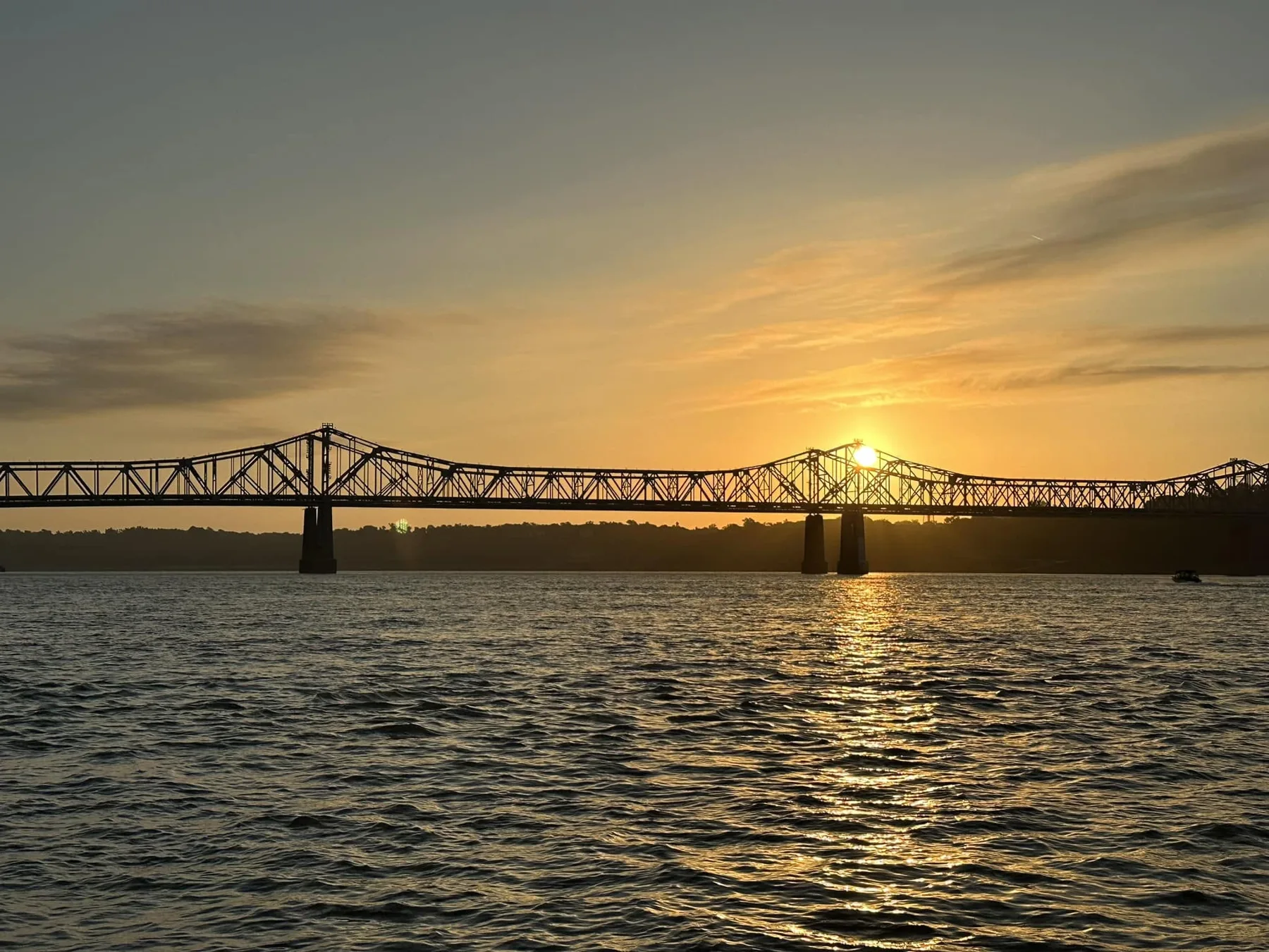 Golden evening light behind a bridge on the Mississippi River